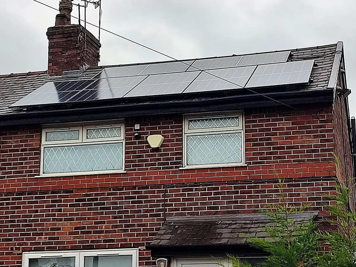 Black guttering and fascias on a red-brick semi-detached house
