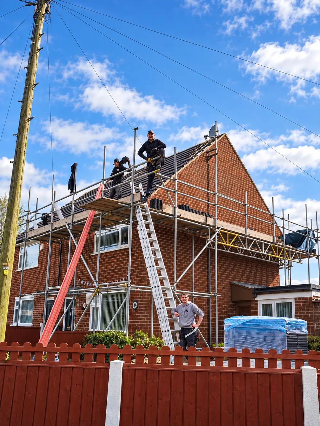 S&S Roofing team re-tiling the roof of a red-brick semi-detached house from scaffolding
